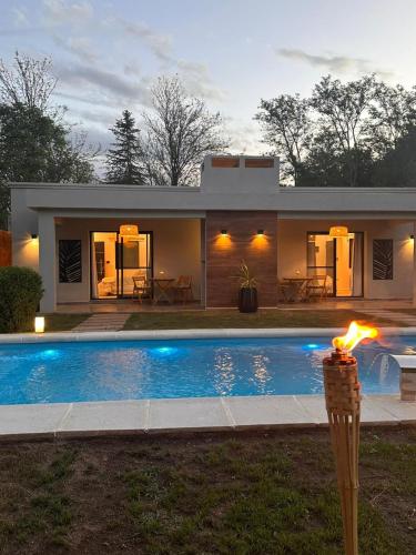a house with a swimming pool in front of it at Magnolia Suites in Nono