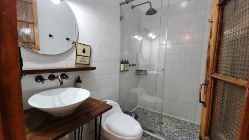 a bathroom with a sink and a shower at Socialtel Candelaria Bogotá in Bogotá