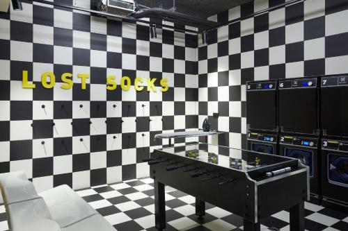 a room with a lost socks sign on a checkered wall at The Social Hub Toulouse Extended Stay in Toulouse