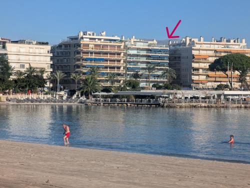 two people standing on a beach near a body of water at Luxury studio next to beaches and old town Antibes in Antibes