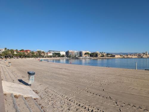 a sandy beach with a trashcan on it next to the water at Luxury studio next to beaches and old town Antibes in Antibes