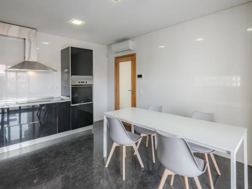 a kitchen with a large white table and chairs at Dom Carlos Villa in Vila Nova de Gaia