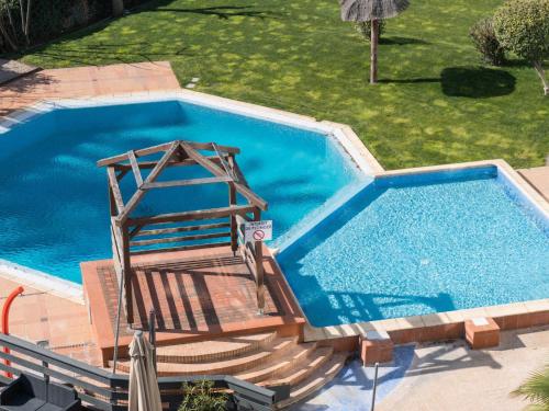 an overhead view of a swimming pool with a wooden stairwayministic at ibis Styles Perpignan Canet En Roussillon in Canet-en-Roussillon