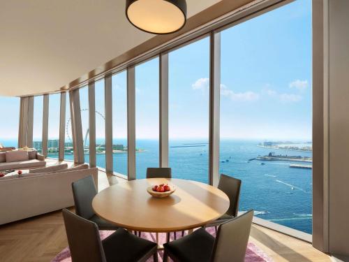 a dining room with a table and a view of the ocean at Rixos Premium Dubai JBR in Dubai