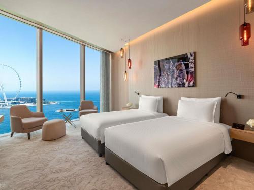 a hotel room with two beds and a view of the ocean at Rixos Premium Dubai JBR in Dubai