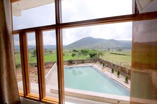 a view of a pool from a window at Narayani Bag Resort & Restaurant 