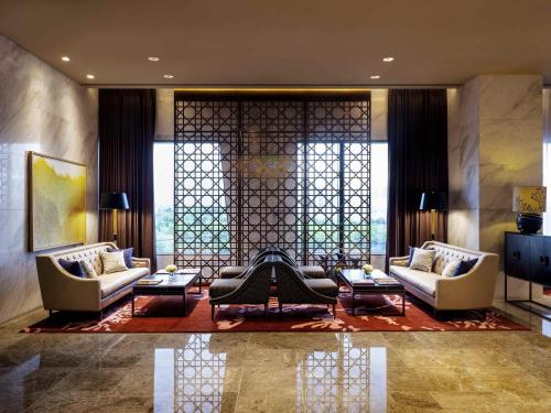 a living room with two couches and a table at Grand Mercure Ambassador Hotel and Residences Seoul Yongsan in Seoul