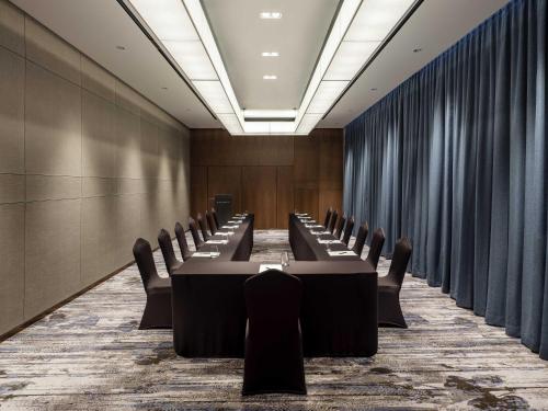 a conference room with a long table and chairs at Novotel Suites Ambassador Seoul Yongsan in Seoul