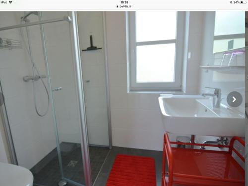 a bathroom with a glass shower and a sink at Haus Waldblick in Winterberg