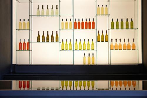 a glass display case with different types of wine bottles at Shilla Stay Gangnam Yeoksam in Seoul