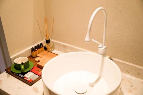 a bathroom with a white sink and a faucet at Lu Ming Beiyuan Xi'an Zhongdu Drum Tower City Wall Store in Xi'an