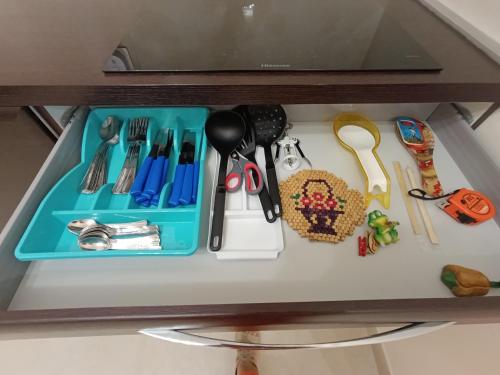 a shelf with a tray of utensils on it at Residenza Orchidea in Tarquinia
