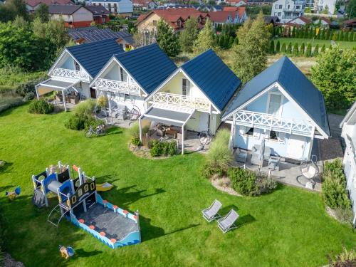 an aerial view of a row of cottages at Domki nad morzem Otulone Słońcem in Rowy