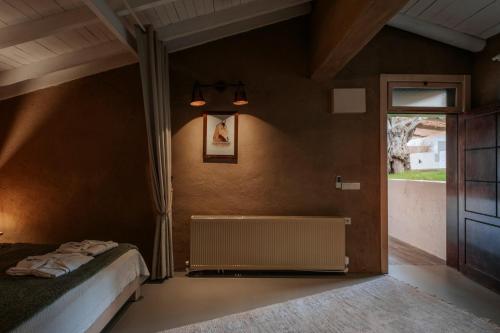 a bedroom with a bed and a window at MANEJ URLA in Izmir