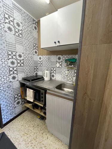 a small kitchen with a sink and a counter at Joana's House in La Grande-Motte