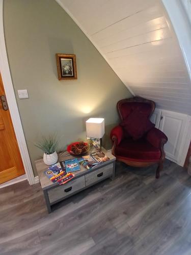 a living room with a chair and a table at Oaktree Manor in Castlewellan