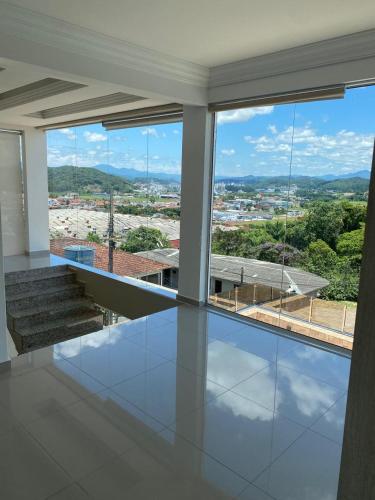 an empty house with a view of a city at Doce Despertar Suítes in Brusque