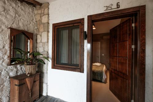an open door to a room with a potted plant at MANEJ URLA in Izmir