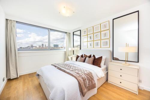 a bedroom with a white bed and a large window at Marylebone in London