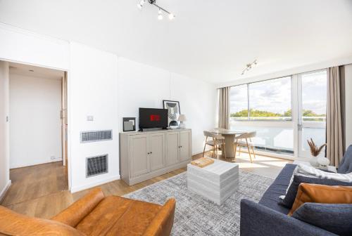 a living room with a couch and a tv at Marylebone in London