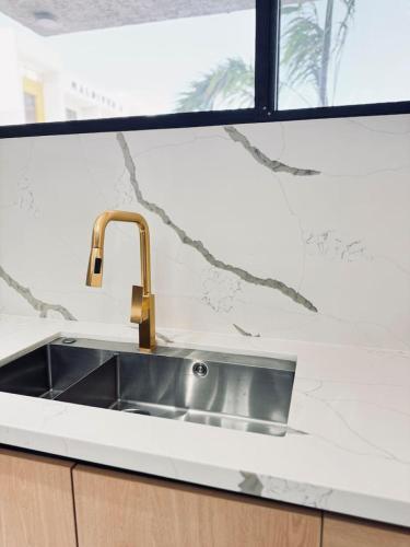a stainless steel sink in a kitchen with a window at The Nest At Paradisiac in Ocho Rios