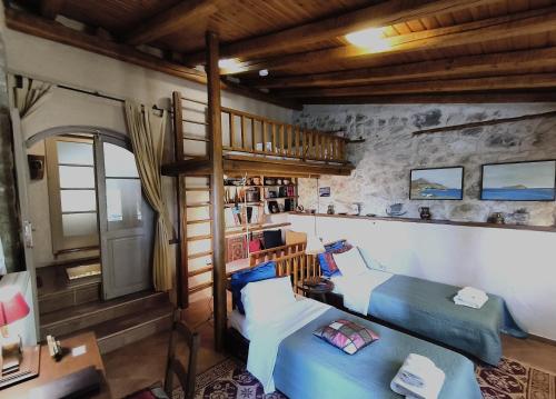 a room with two beds and a bunk bed at Agoriani Art Suite - 4 seasons' natural living in Lílaia