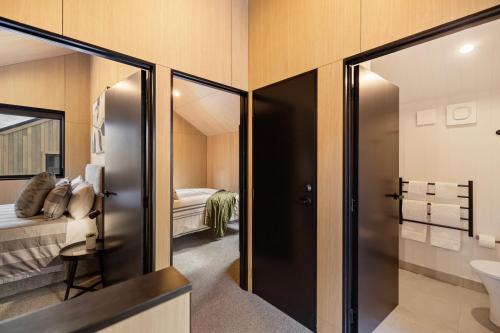 a bathroom with a toilet and a sink at Villa XV Stylish and Contemporary Escape in Queenstown Airport
