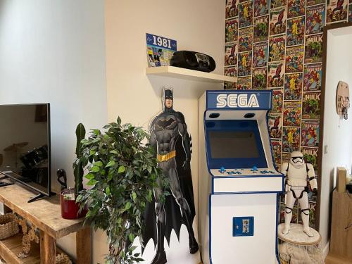 a batman themed room with a costume next to a cash register at Loft Lumineux, Échappez à l'ordinaire proche Nancy in Saint-Max