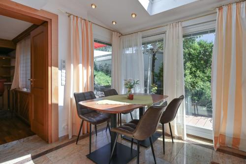 a dining room with a table and chairs and a large window at Hotel San Marco in Füssen