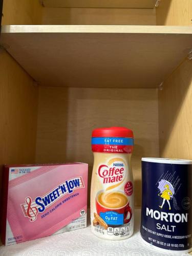 a shelf with two cups of coffee and a container of food at Serene Living 5 Min From Downtown in Wilders Grove