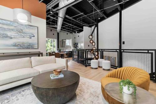 a living room with a couch and a table at Serene Living 5 Min From Downtown in Wilders Grove