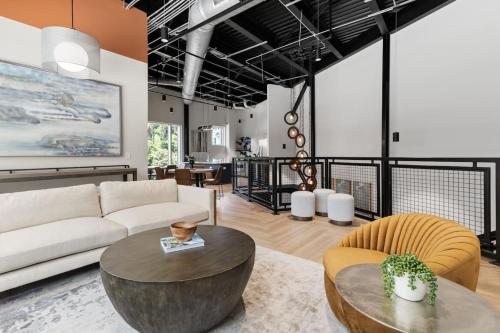 a living room with a couch and a table at Stunning Living 5 Min From Downtown in Wilders Grove