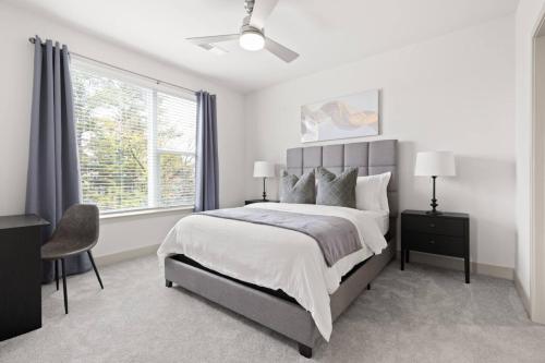 a bedroom with a large bed and a window at The Icon 5 Min From Downtown in Wilders Grove