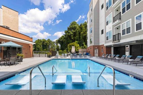 a swimming pool in a courtyard of a building at Blissful Living 5 Min From Downtown in Wilders Grove