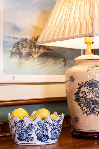 a lamp and a bowl of lemons on a table at KAROO RANCHING Townhouse in Graaff-Reinet