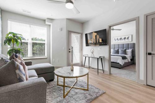 a living room with a couch and a table at Blissful Living 5 Min From Downtown in Wilders Grove