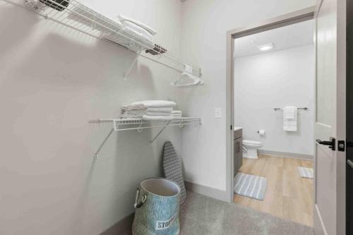 a bathroom with a toilet and a trash can at Blissful Living 5 Min From Downtown in Wilders Grove