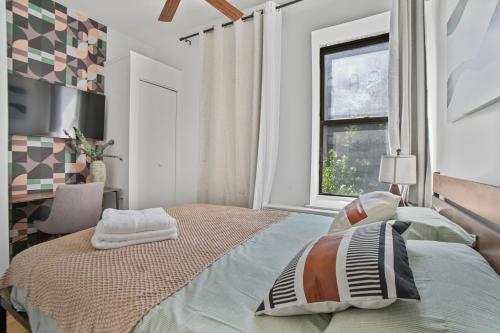 a bedroom with a large bed and a window at 2 BD Tranquil Unit close to Central Park in New York