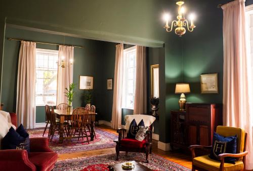 a living room with a table and chairs at KAROO RANCHING Townhouse in Graaff-Reinet