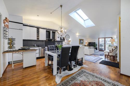 a kitchen and living room with a table and chairs at Modern flat in the citycenter Helsinki in Helsinki