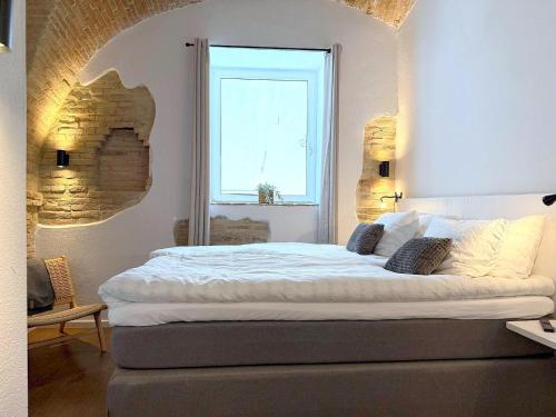 a bedroom with a large bed with a window at Charming Boutique B&B Hotel in Villalfonsina