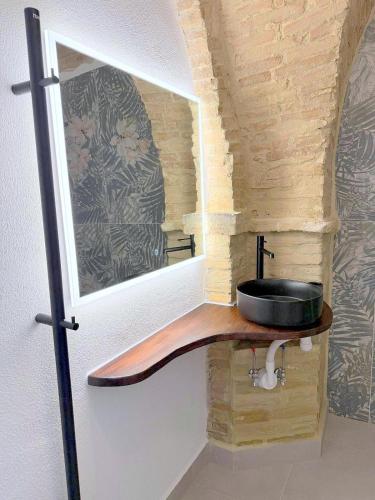 a bathroom with a wooden sink and a mirror at Charming Boutique B&B Hotel in Villalfonsina
