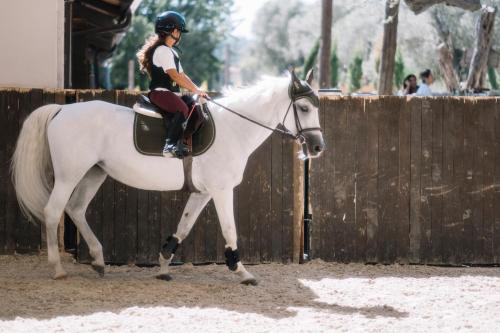 a woman is riding a white horse at MANEJ URLA in Izmir