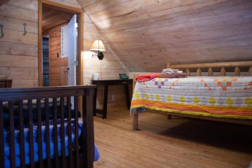 a bedroom with a bed and a wooden wall at Project Chimps Historic Cabin in Morganton
