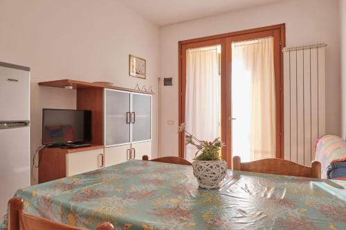 a dining room with a table with a vase on it at Homely flat with pool-Beahost in Rosapineta