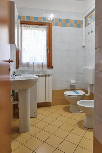 a bathroom with a sink and a toilet at Homely flat with pool-Beahost in Rosapineta