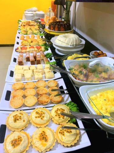 a buffet line with many different types of food at Pousada Michele in Morro de São Paulo