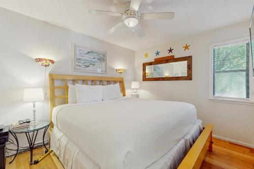 a bedroom with a white bed and a ceiling fan at Beachwood Villas 7C in Seagrove Beach