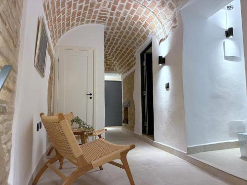 a living room with a chair and a table at Charming Boutique B&B Hotel in Villalfonsina