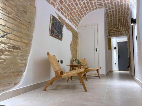 a hallway with two chairs and a table in a building at Charming Boutique B&B Hotel in Villalfonsina